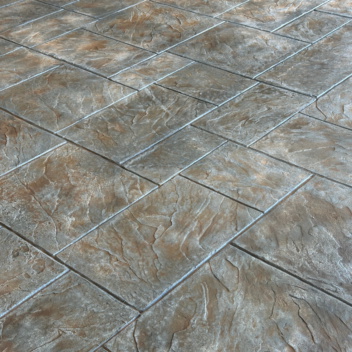 Noble Ashler Slate stamped concrete with Char Green integral color and Tru Tique Copper and Sandstone antiquing wash