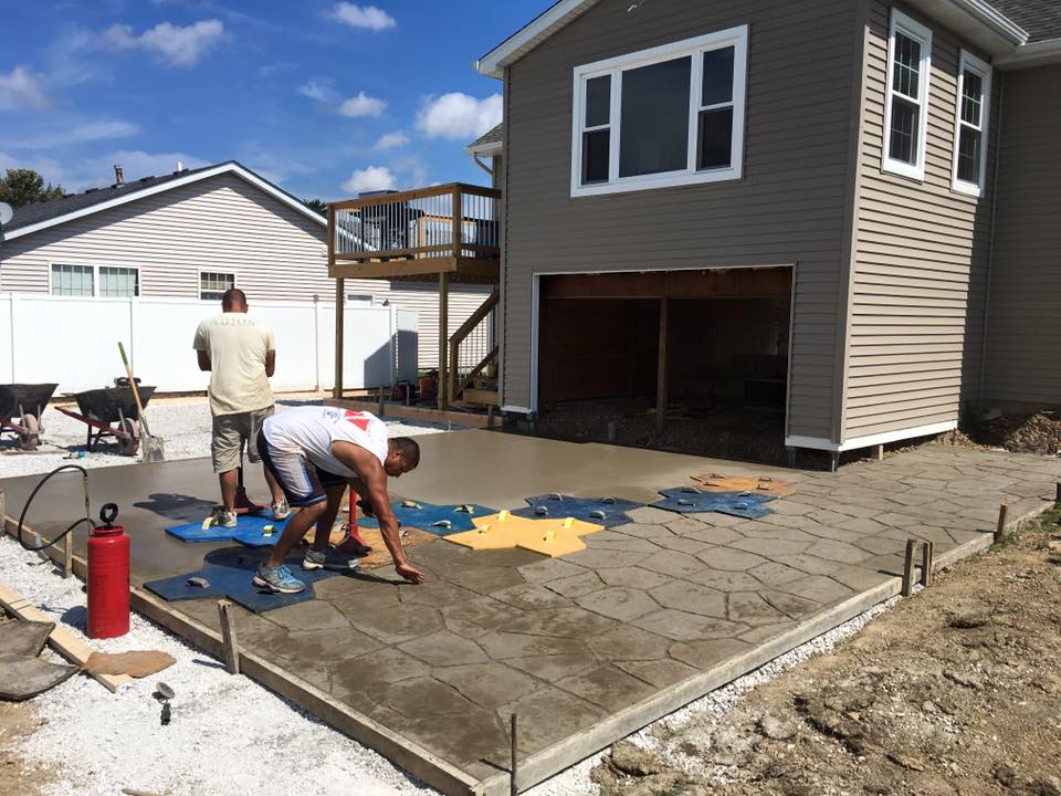 Contractor spraying liquid release on freshly poured concrete